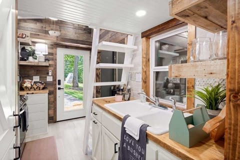 🍷🌲 Craft culinary delights with stylish glassware and warm wood finishes.