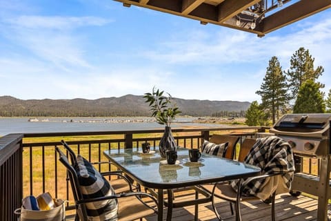 Lakefront views out on the patio with a gas BBQ and seating for four.