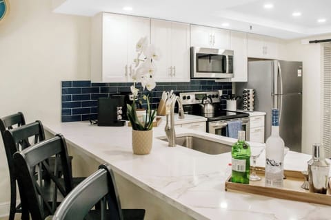 Bar seating for 4 open to the kitchen, living, and dining area. 