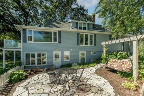 Side yard with patio swing, table and bbq