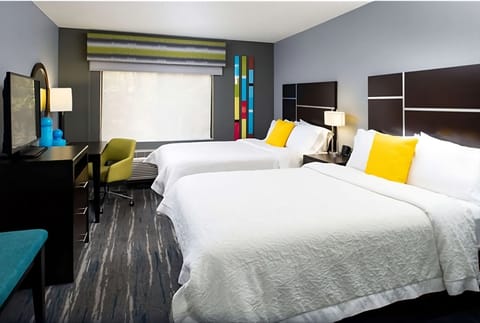 Unwind in bright double-queen comfort with bold modern style.