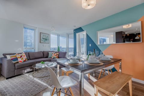 Bright and inviting, this open-plan living and dining area offers a stylish space to gather, dine, or unwind. Floor-to-ceiling windows frame beautiful city views, adding a touch of Vancouver charm to every stay.