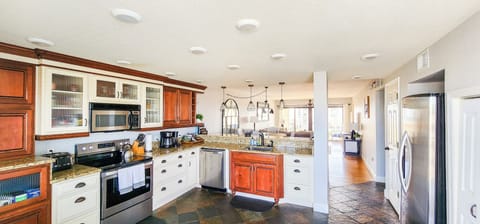 Full size kitchen with stove, refrigerator and dishwasher