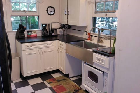 Honed Granite Countertops with $1100 Stainless Steel Farmsink in this updated kitchen. Open area underneath sink was designed as a pet feeding station. Pico Remote control at the back door runs the Welcome Home Scene, Relax Scene and All Off Scene. Never walk in the dark in this Townhome!    