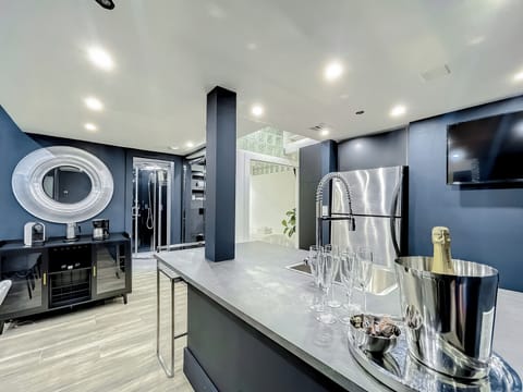 Entertain with big screens, a stone table for 12, and a fully-equipped kitchen