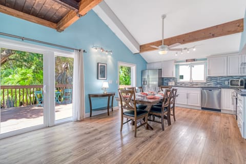 Enjoy bright mornings and sunset dinners with the dining area's stunning view of the deck and pool beyond.