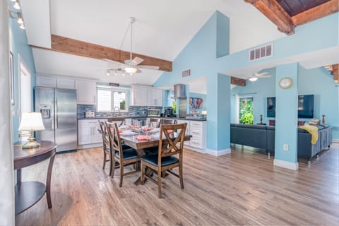 Feel the inviting flow as the kitchen and dining area blend seamlessly into the cozy living room, perfect for shared meals and relaxed conversations.