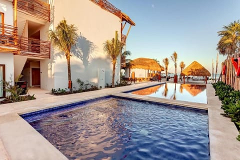 Float into golden hour in the serene, palm-lined pool.