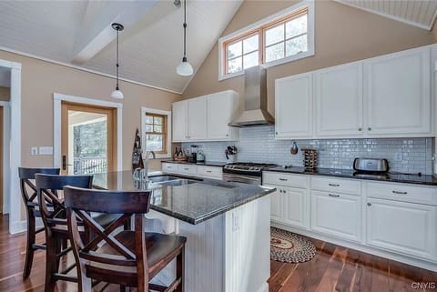 Kitchen access to the back patio (w/ charcoal grill) and to the screened porch 