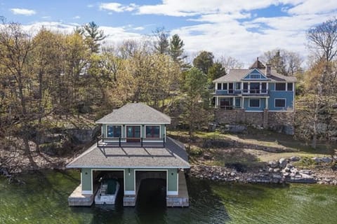 Front view of property. Stairs lead from behind boathouse to a stone stairway.