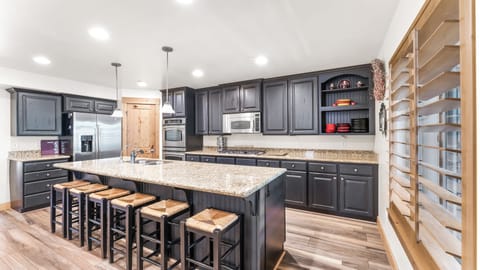 - Wide granite counters and black cabinets give the kitchen a bold style  
- Breakfast bar with seating for six creates a great family gathering spot  
- Fully equipped with microwave, oven, and storage for all essentials