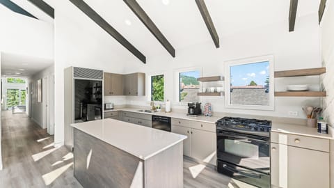 - Kitchen with large island and sleek countertops  
- Modern cabinetry and open shelving for essentials  
- Bright windows with scenic mountain views