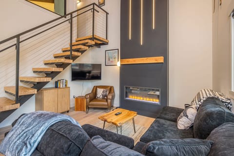 Relax on the couch and enjoy the custom fireplace!