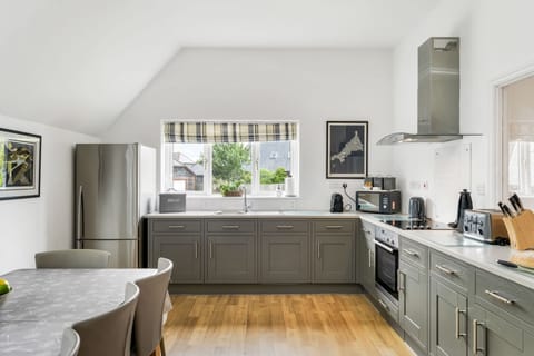 The Hawthorns, Roserrow, First Floor: The well-equipped kitchen/Dining area  with electric oven and hob, fridge/freezer, dishwasher, coffee machine, Smart television and dining for ten guests.