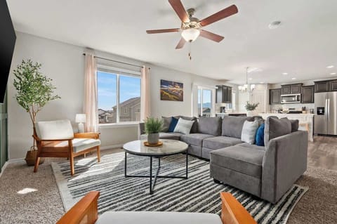 Cozy sectional sofa, 65" TV, base green accent wall