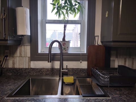 Double kitchen sink has goos view to street.