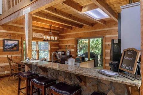 Four seats at the bar in the kitchen area. Kitchen table has eight seats.