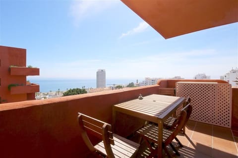 Apartment terrace with outdoor dining area for four guests and beautiful sea views