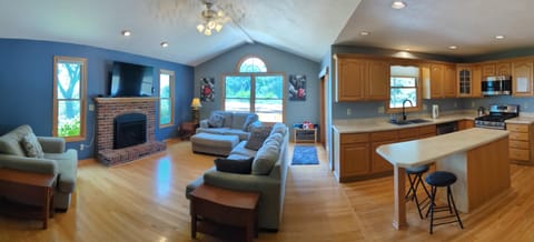 open concept kitchen, center island, family room, gas fireplace