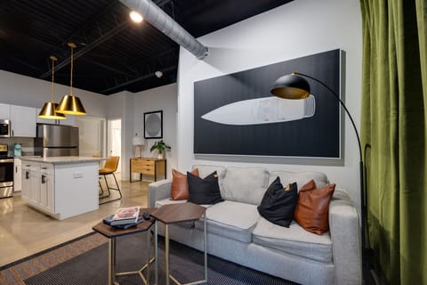 Prepare to be impressed by the seamless blend of comfort and elegance in this apartment's spacious living area, complete with a well-equipped kitchen.