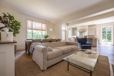 Kitchen, sitting and dining area with table seating eight guests