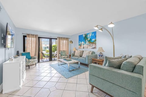 Relax in this bright living room with garden access and coastal-inspired decor.