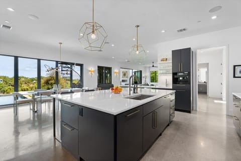 Fully equipped kitchen with modern appliances and a spacious island, perfect for cooking and gathering.