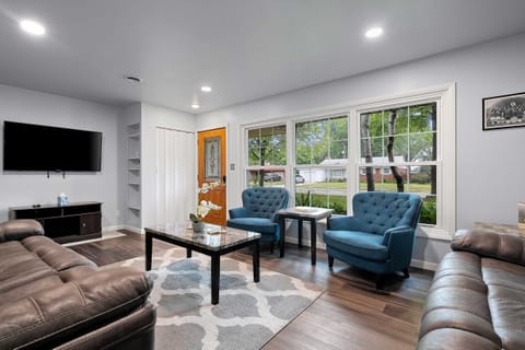 Spacious living room offers plenty of seating with power reclining sofas and two accent chairs. Plus a smart TV. 