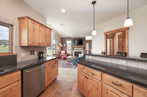 Your gourmet kitchen flows seamlessly into the living area, creating the perfect space for cooking and entertaining with mountain views.