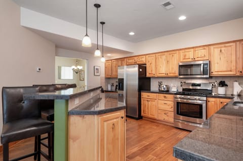 Your gourmet kitchen features granite counters, stainless appliances, and a spacious island perfect for cooking memorable meals together.