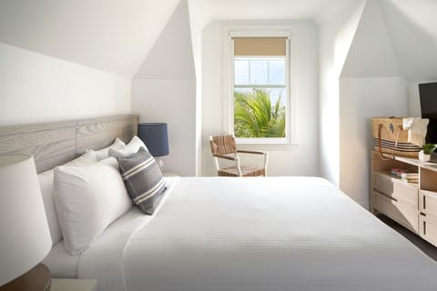 Drift off in a calm coastal bedroom with leafy views.