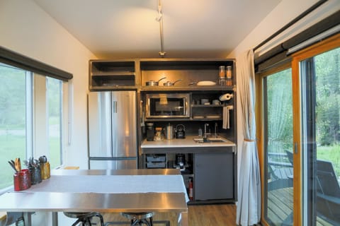 Kitchen includes fridge, freezer, small convection oven, and 2 burner cooktop