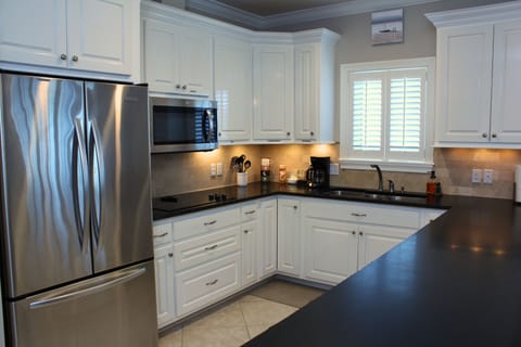 The kitchen is equipped with modern appliances and all the essentials you need