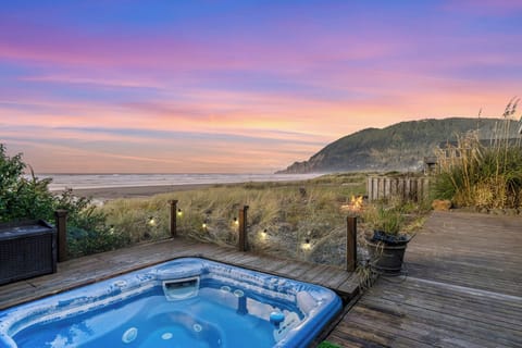 hot tub and firepit facing the ocean and mountains.