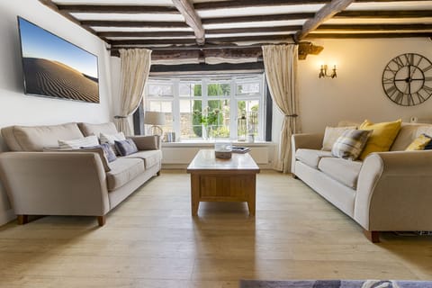 Open plan lounge and dining room with wood burning stove
