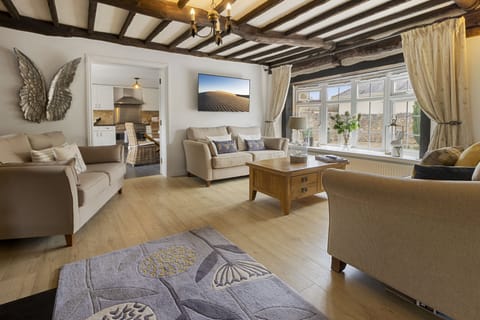 Open plan lounge and dining room with wood burning stove