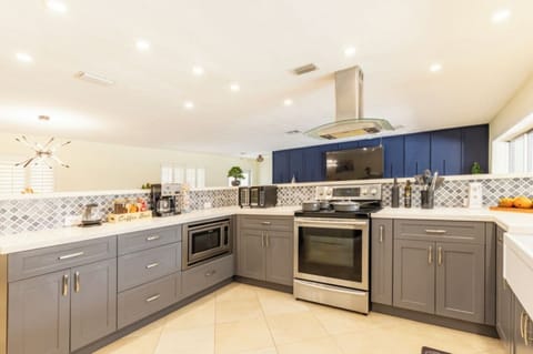 Open kitchen with stove, coffee maker, toaster