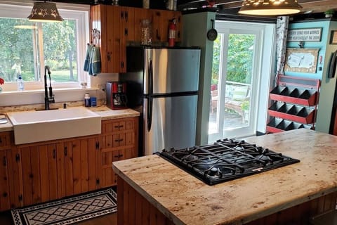 Gas stove, large porcelain farm sink, kitchen island for additional seating.