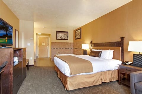 Unwind in a spacious king room with warm lighting.