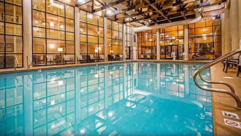 Dive into a sparkling indoor pool beneath soaring timber beams.