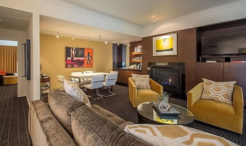 Suite with King bed, living area, dining table, wet bar and fireplace