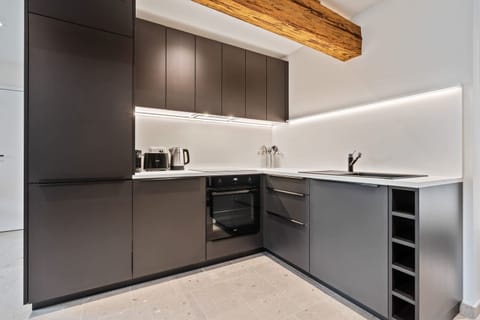 Experience the perfect blend of modern design and rustic charm in our kitchen, featuring sleek appliances and a beautiful exposed beam.