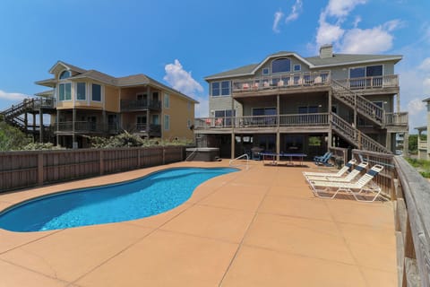 Back exterior and private pool and hot tub - Enjoy this private 15 by 34 heated pool and hot tub. Ping pong table is not included.