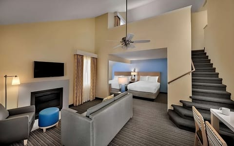 Unwind in the spacious suite with lounge seating and stairs.