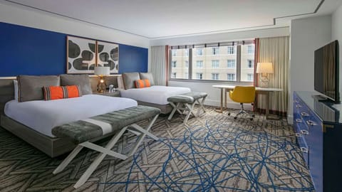 Stretch out in a spacious double-queen room with sunny workspace.