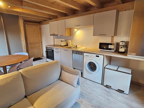 The compact kitchen includes a dishwasher, washing machine, and more.