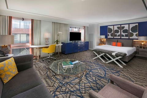 Unwind in a stylish suite with lounge seating and king bed.