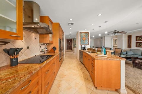 Fully equipped kitchen with stainless steel appliances and wooden cabinetry