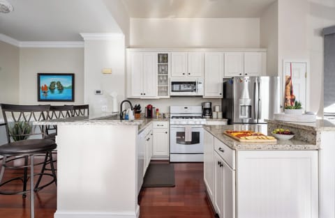 This kitchen has a gas oven AND an electric oven. Help yourself to the fridge!