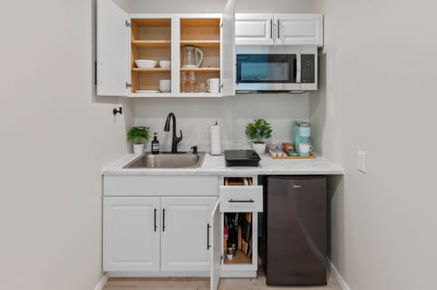 Stocked kitchen w/ electric kettle, toaster, electric stove, dishes, and more